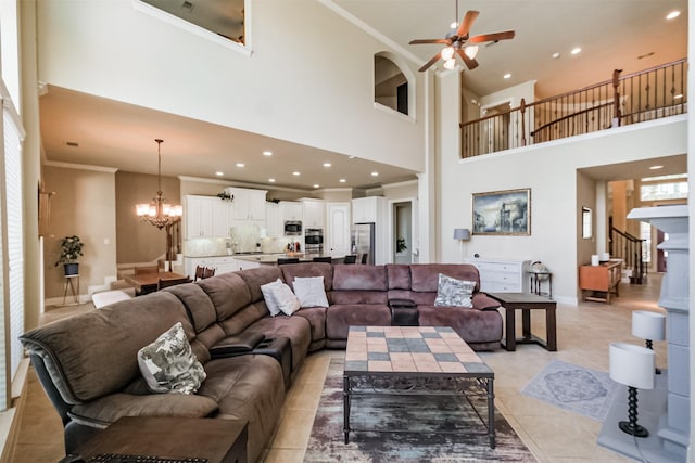 2402 Chesley Park Ct, Katy, TX 77494 - living area with a high ceiling, a chandelier, ornamental molding, a ceiling fan, and stairs