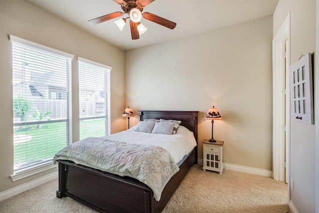 2402 Chesley Park Ct, Katy, TX 77494 - bedroom with multiple windows, baseboards, carpet floors, and ceiling fan
