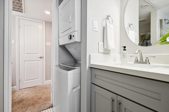 1201 Mcduffie St Unit 169, Houston, TX 77019 - bathroom featuring stacked washer / dryer and vanity