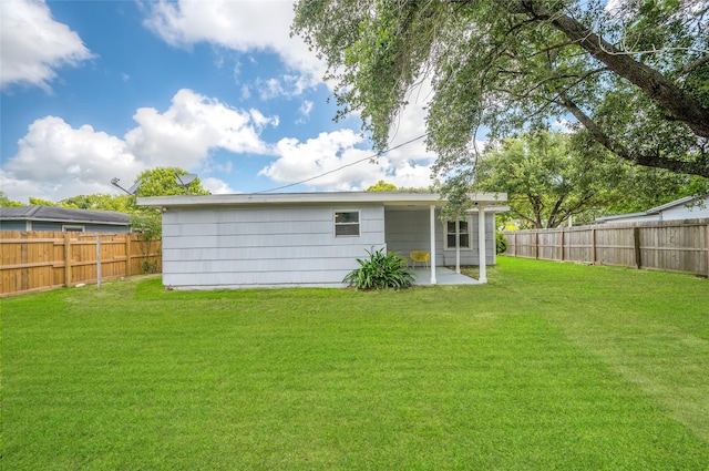 409 24th Ave N, Texas City, TX 77590 - rear view of house with a fenced backyard and a patio