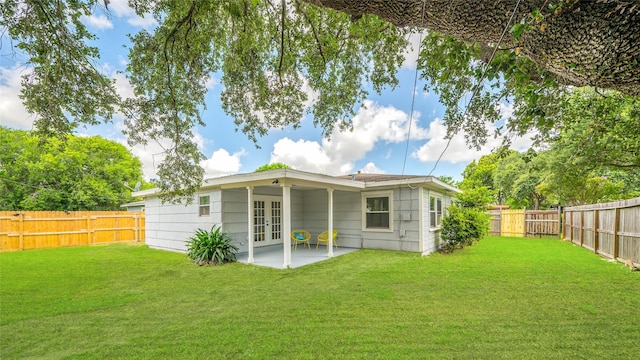 409 24th Ave N, Texas City, TX 77590 - back of property featuring french doors, a fenced backyard, and a patio