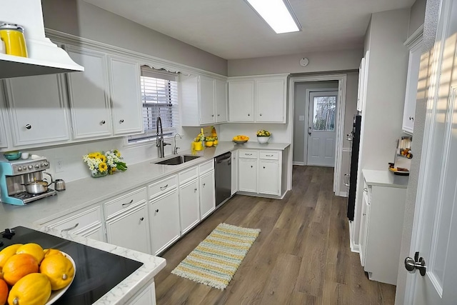 kitchen featuring white cabinets, dark wood-style flooring, a sink, dishwasher, and light countertops