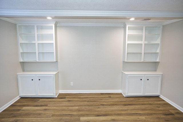 empty room with baseboards, dark wood finished floors, and ornamental molding