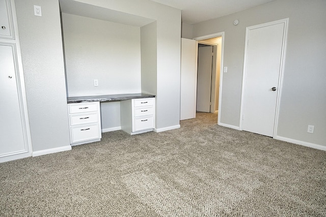 unfurnished bedroom featuring baseboards and light colored carpet