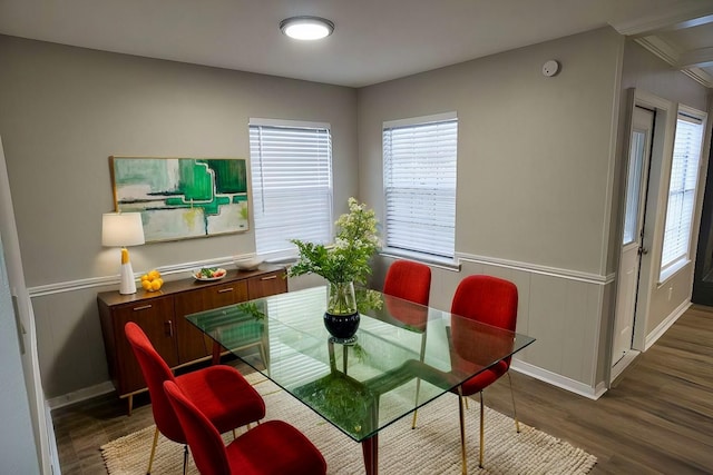 dining space with baseboards, wainscoting, and wood finished floors