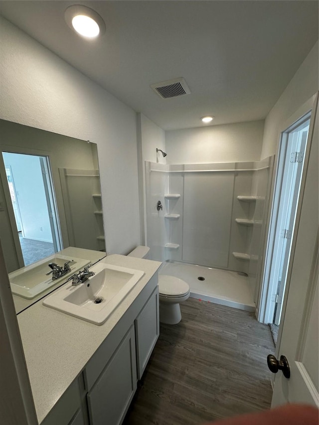 10819 Red Orchid Dr, Houston, TX 77016 - full bath featuring wood finished floors, a shower stall, vanity, toilet, and recessed lighting