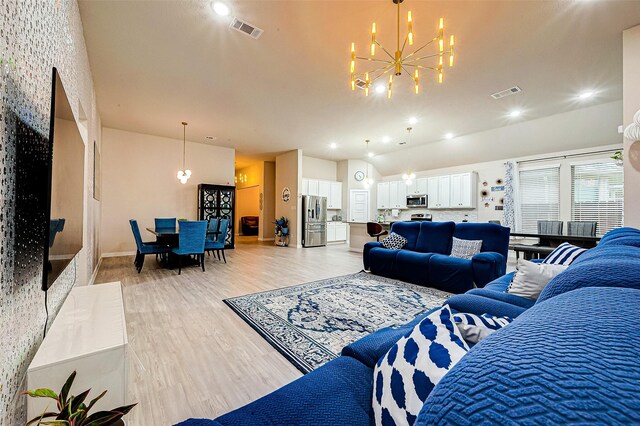 4723 Great Acre Ln, Fresno, TX 77545 - living area with an inviting chandelier, lofted ceiling, light wood-style flooring, and visible vents