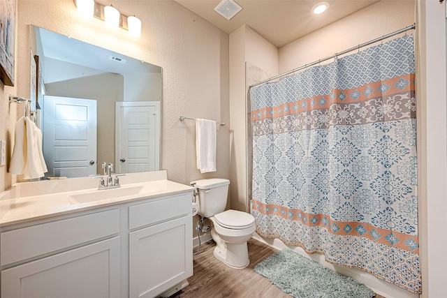 4723 Great Acre Ln, Fresno, TX 77545 - bathroom featuring vanity, toilet, wood finished floors, and visible vents