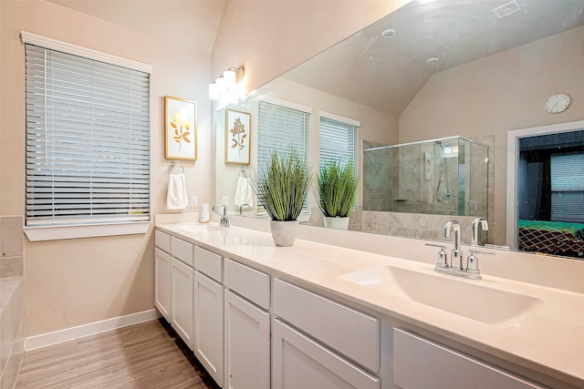 4723 Great Acre Ln, Fresno, TX 77545 - full bath with wood finished floors, double vanity, a sink, and a stall shower