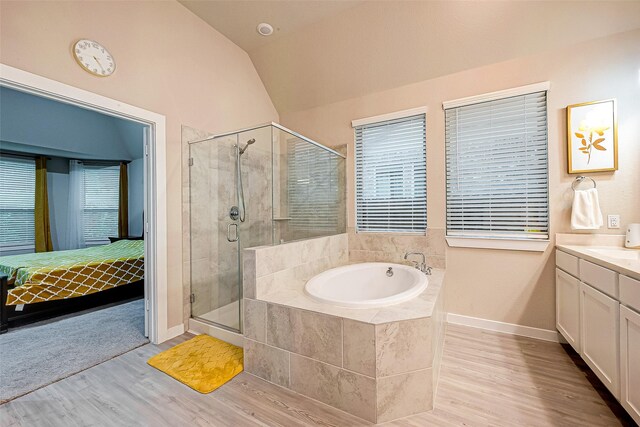 4723 Great Acre Ln, Fresno, TX 77545 - bathroom with wood finished floors, ensuite bathroom, lofted ceiling, a bath, and a stall shower