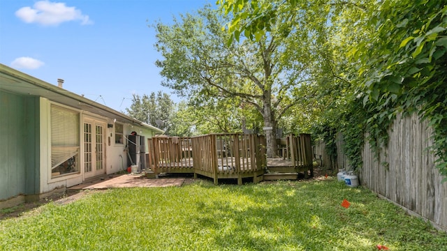 view of yard with a fenced backyard and a wooden deck