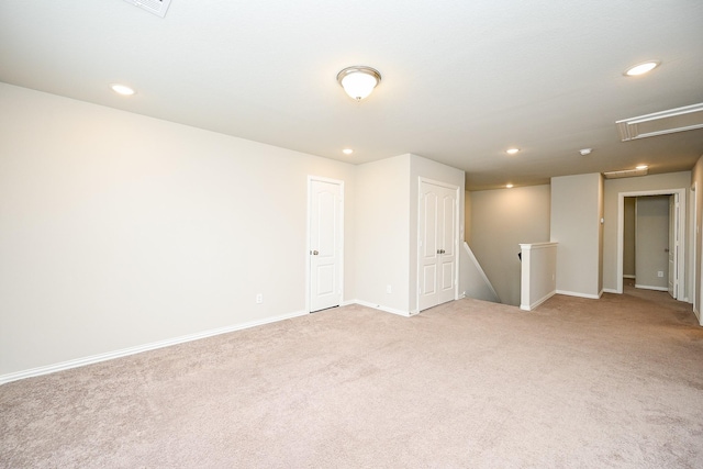 unfurnished room featuring baseboards, light carpet, attic access, and recessed lighting