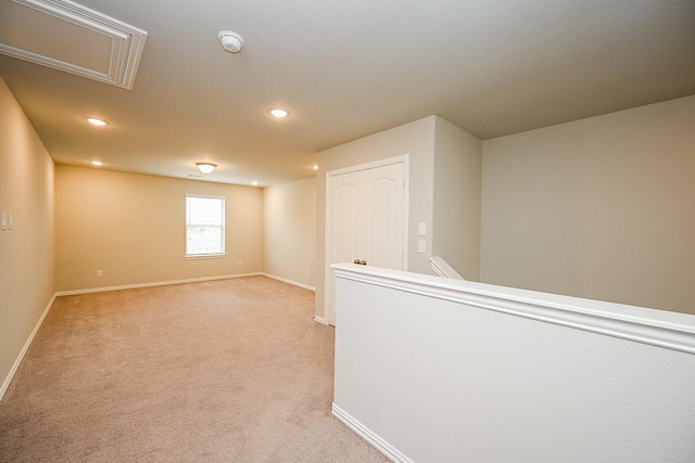 below grade area with baseboards, recessed lighting, and light colored carpet