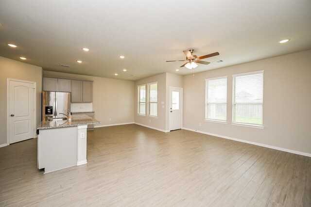 8310 Divot Trce, Fulshear, TX 77441 - kitchen with stainless steel refrigerator with ice dispenser, gray cabinetry, ceiling fan, recessed lighting, and baseboards