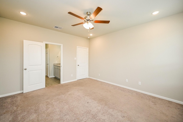 unfurnished bedroom with baseboards, light carpet, recessed lighting, and visible vents