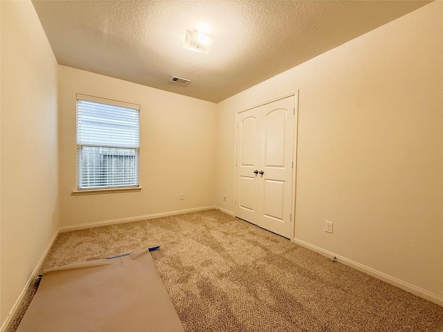 2093 Saras Way, Brookshire, TX 77423 - empty room featuring baseboards, carpet flooring, a textured ceiling, and visible vents
