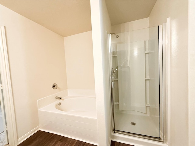 2093 Saras Way, Brookshire, TX 77423 - bathroom featuring wood finished floors, a bath, and a stall shower