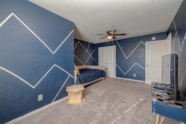 carpeted bedroom with visible vents, a textured ceiling, baseboards, and ceiling fan