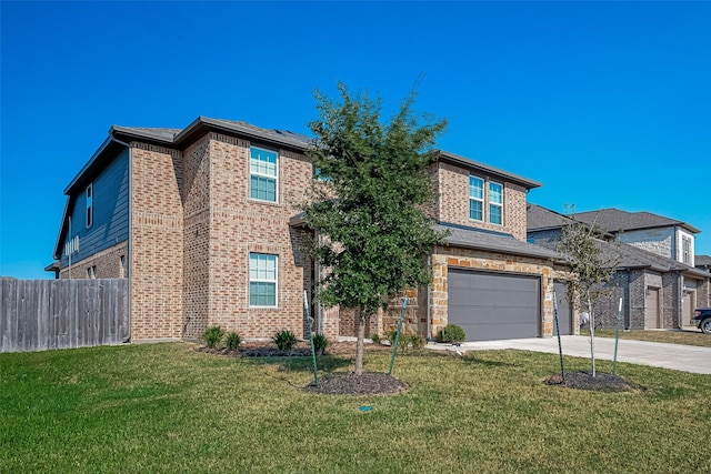traditional home featuring brick siding, fence, a front lawn, concrete driveway, and an attached garage