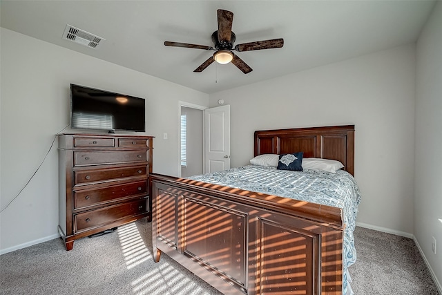 bedroom featuring a ceiling fan, baseboards, visible vents, and light carpet