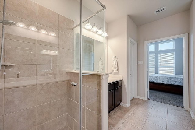 bathroom featuring baseboards, tile patterned floors, visible vents, and a shower stall