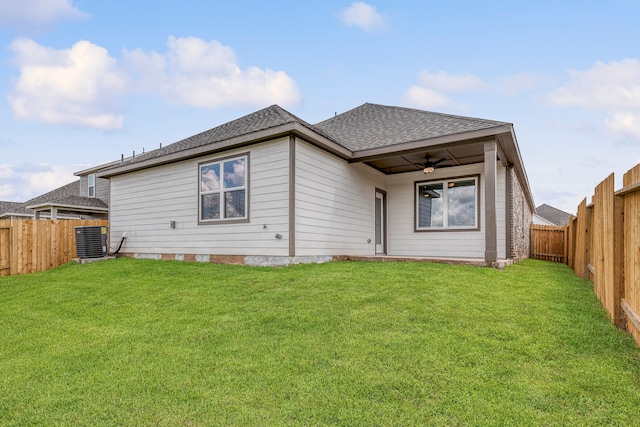 15679 Honey Cove Dr, Conroe, TX 77303 - back of house with a fenced backyard, ceiling fan, central AC, and a yard
