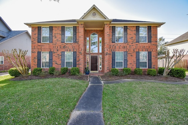 9706 Garden Row Dr, Sugar Land, TX 77498 - view of front facade with fence, a front yard, and brick siding
