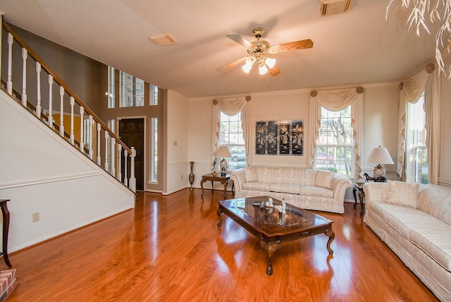 9706 Garden Row Dr, Sugar Land, TX 77498 - living area with stairway, ceiling fan, ornamental molding, and visible vents