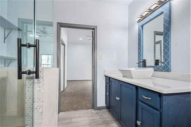 full bath with vanity, walk in shower, and wood finished floors