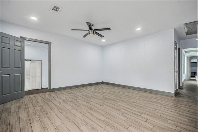 empty room with ceiling fan, visible vents, wood finished floors, baseboards, and recessed lighting