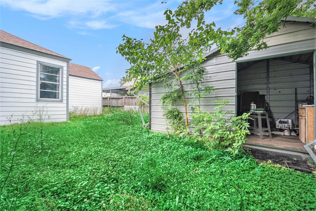 view of yard featuring fence and a deck