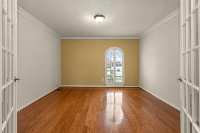 11406 Carson Ave, Pearland, TX 77584 - empty room with crown molding, baseboards, and wood finished floors