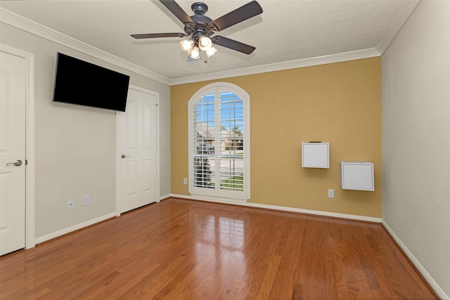 11406 Carson Ave, Pearland, TX 77584 - spare room featuring a ceiling fan, baseboards, ornamental molding, and wood finished floors