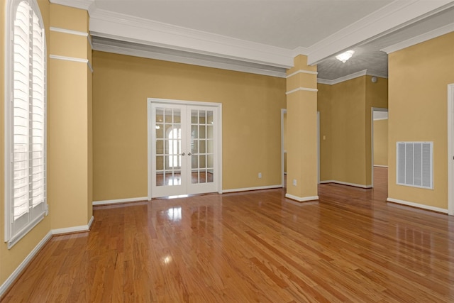 11406 Carson Ave, Pearland, TX 77584 - spare room featuring french doors, visible vents, crown molding, wood finished floors, and baseboards