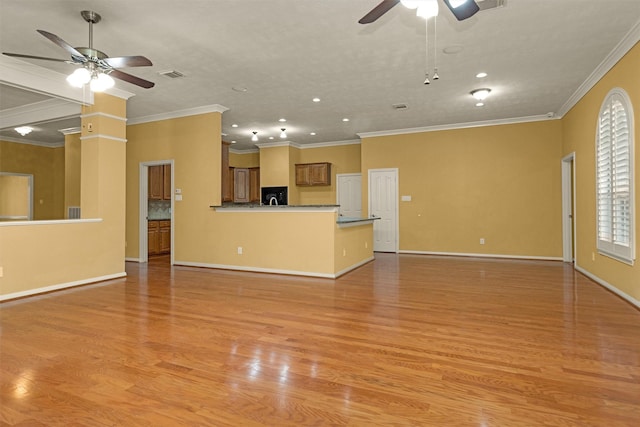 11406 Carson Ave, Pearland, TX 77584 - unfurnished living room featuring light wood-style floors, ceiling fan, ornamental molding, and visible vents