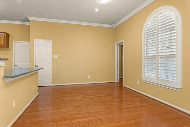 11406 Carson Ave, Pearland, TX 77584 - empty room with light wood-style floors, ornamental molding, and a wealth of natural light