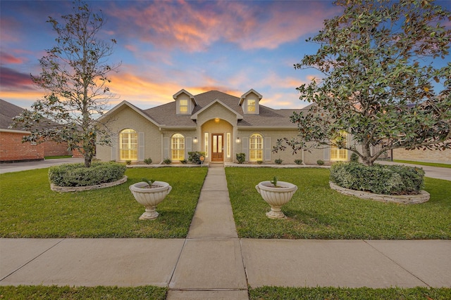 11406 Carson Ave, Pearland, TX 77584 - traditional-style house featuring brick siding, a shingled roof, and a front yard
