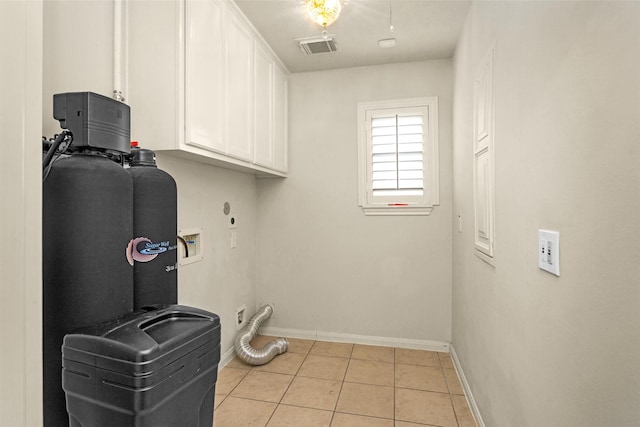 11406 Carson Ave, Pearland, TX 77584 - washroom featuring washer hookup, visible vents, cabinet space, light tile patterned floors, and baseboards