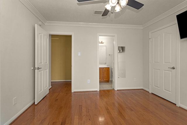 11406 Carson Ave, Pearland, TX 77584 - unfurnished bedroom with ensuite bath, baseboards, wood finished floors, visible vents, and ornamental molding