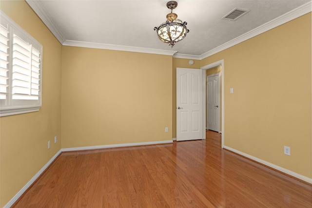 11406 Carson Ave, Pearland, TX 77584 - spare room featuring an inviting chandelier, baseboards, wood finished floors, and visible vents