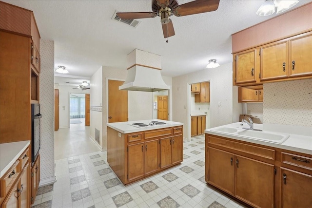kitchen featuring ceiling fan, a sink, white electric stovetop, wall oven, and visible vents