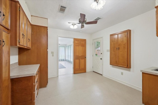entrance foyer featuring baseboards, a ceiling fan, and visible vents