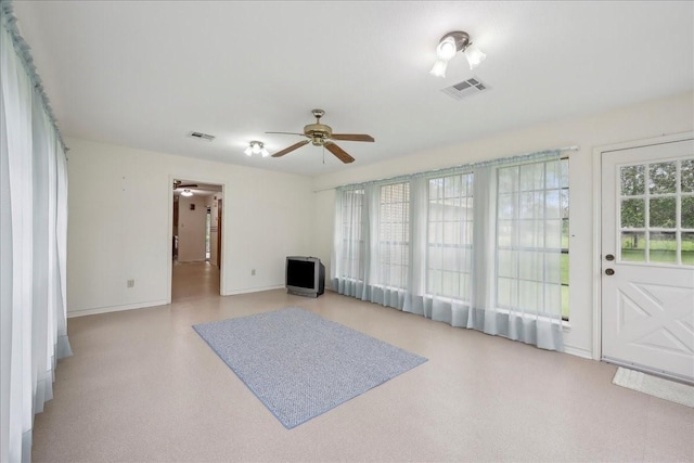 unfurnished living room featuring baseboards, ceiling fan, and visible vents