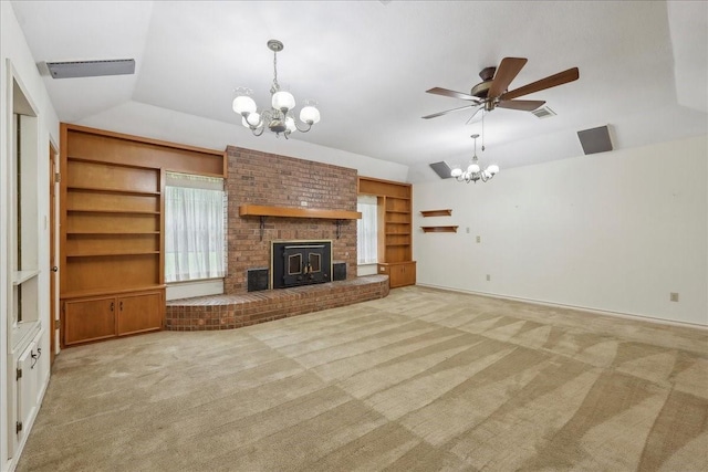 unfurnished living room with visible vents, lofted ceiling, light carpet, a fireplace, and ceiling fan with notable chandelier