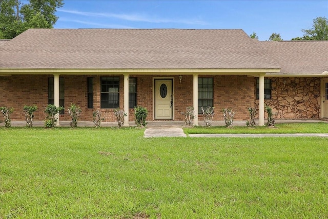 single story home featuring a porch, brick siding, roof with shingles, and a front yard