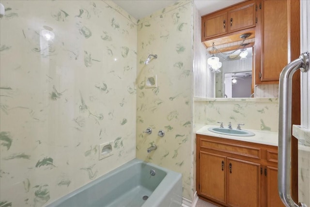 bathroom with shower / bath combination, vanity, and wallpapered walls