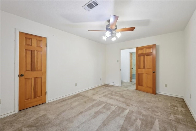 unfurnished room with visible vents, a ceiling fan, carpet, and baseboards