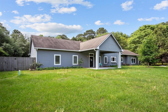 207 W Neyland St, Colmesneil, TX 75938 - rear view of house featuring fence, a yard, a patio area, and roof with shingles