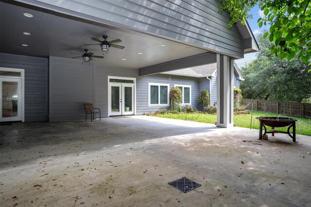207 W Neyland St, Colmesneil, TX 75938 - view of patio / terrace featuring ceiling fan, a fire pit, fence, and french doors