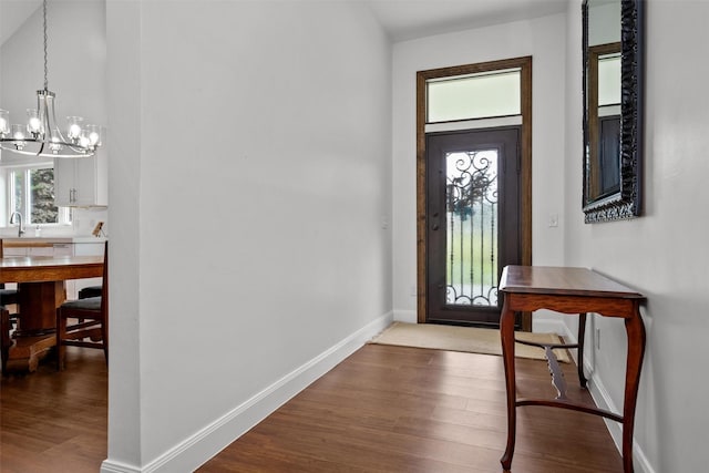 207 W Neyland St, Colmesneil, TX 75938 - interior space with baseboards, an inviting chandelier, and wood finished floors